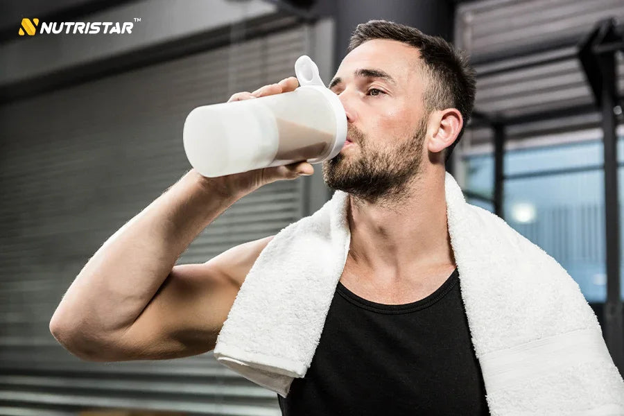 Buy post-workout supplement shake Nutristar, man at gym with towel, fitness nutrition
